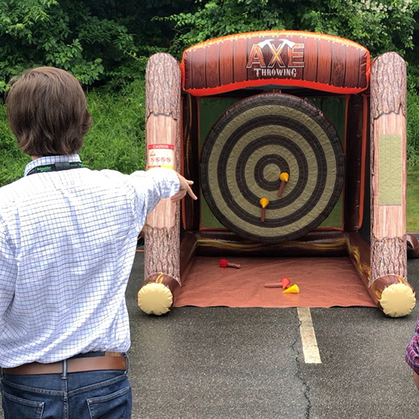 man playing inflatable ax throwing